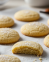 keto sugar cookies recipe on parchment paper dusted with powdered erythritol