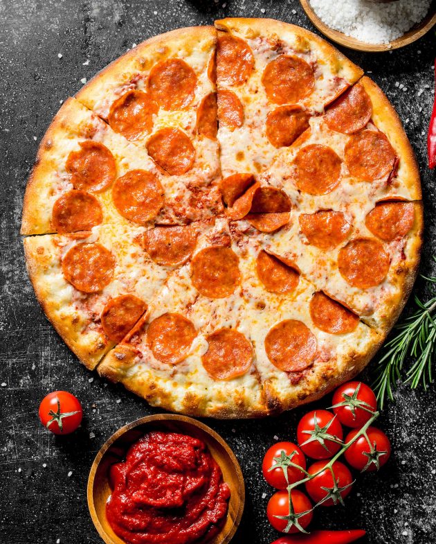 Pepperoni pizza with tomatoes, spices