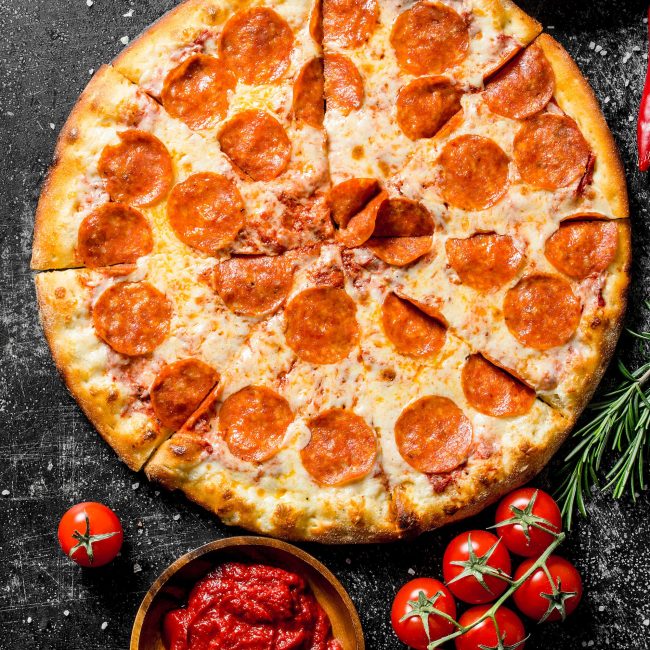 Pepperoni pizza with tomatoes, spices