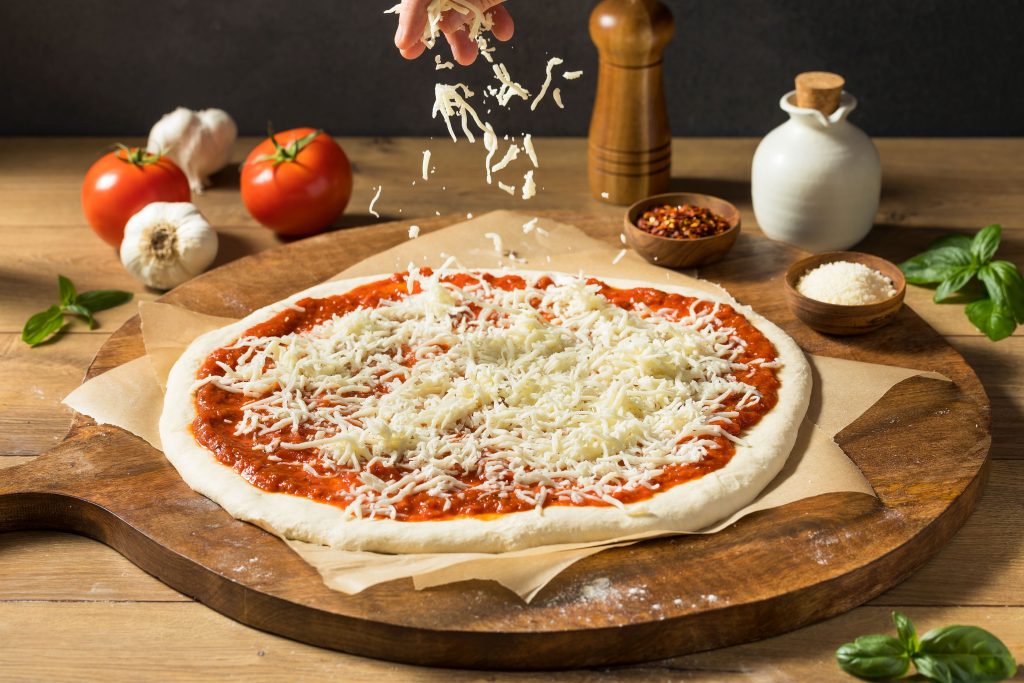 Preparing Homemade Uncooked Cheese PIzza