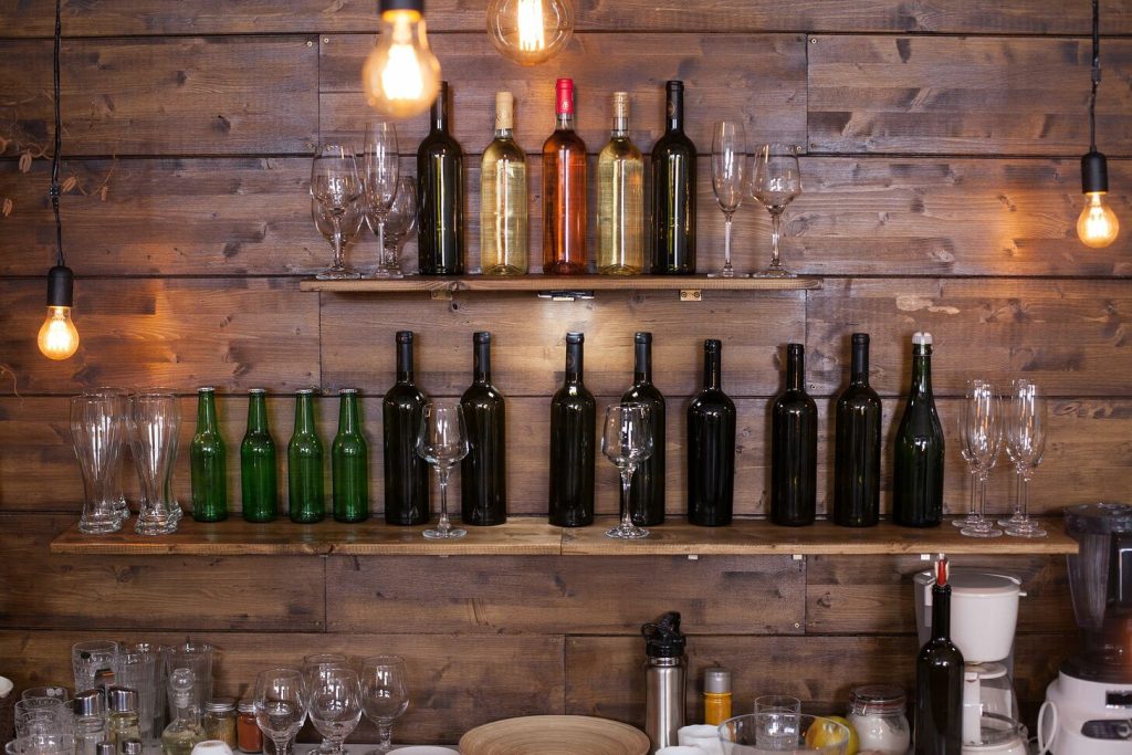 shelves in a pub full of different wine bottles shelves in a pub full of different wine bottles